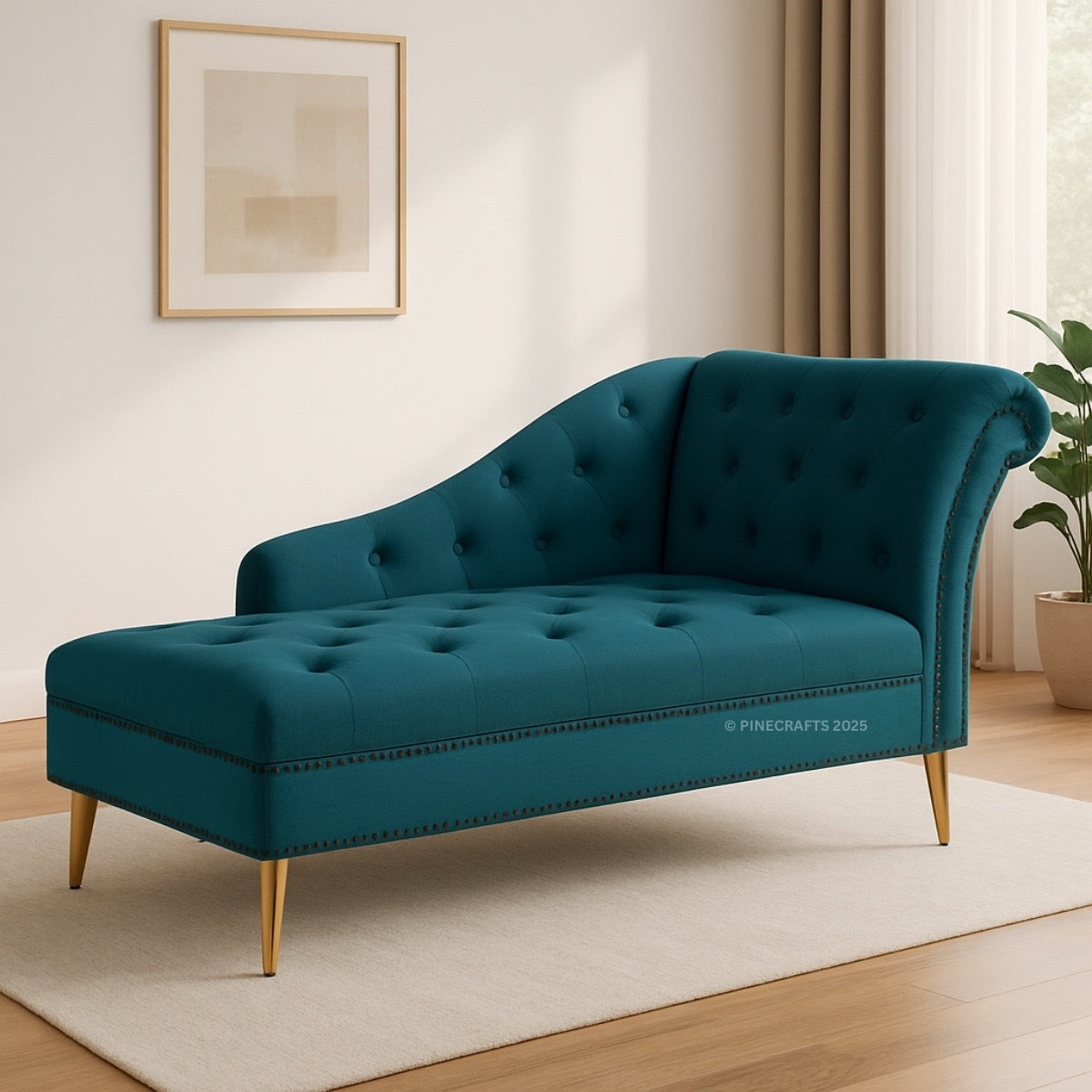 Teal chaise lounge in a room with a plant and framed picture on the wall.
